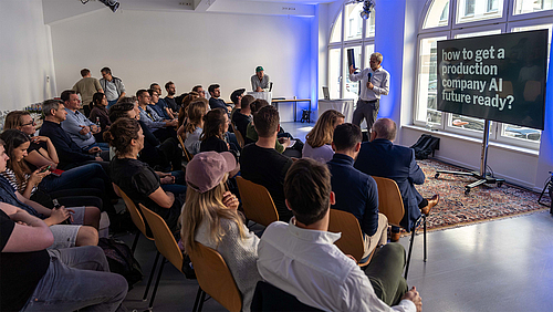 Professor Markus Heinker ist Dekan der Fakultät Medien und einer der Initiator:innen des Media-Production-Masterangebots. Ein Mann mit grauen Haaren und blauem Business-Hemd spricht gestikulierend vor einer im Halbkreis in mehreren Reihen sitzenden Gruppe.